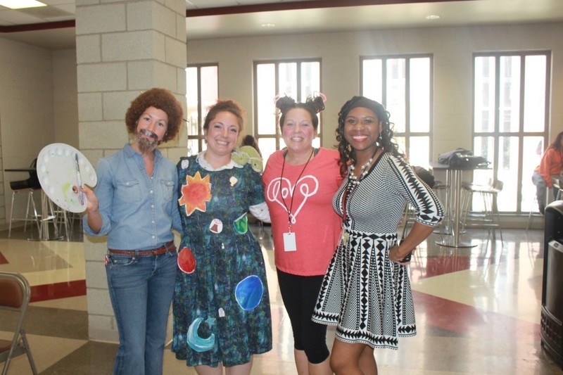 l-r:  Mrs. Coleen Makoski, art teacher, as Bob Ross, Ms. Katelyn Fugel, science teacher, as Mrs. Frizzle from the Magic School Bus, Ms. Sheryll Middleton, science teacher, and Mrs. Tiffani G. Lyles, Assistant Principal, as Lisa Turtle from "Saved By The Bell"